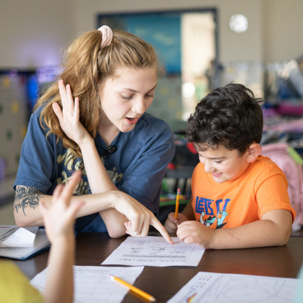 Young woman mentoring boy